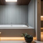 Modern spa bathroom with grey Slatstone Lunarian stone wall panels behind soaking tub, featuring acoustic felt backing and honed matte finish.